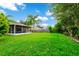 Large backyard with lush grass, screened patio, and privacy fence at 250 White Marsh Cir, Orlando, FL 32824