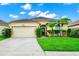 House exterior showcasing a two-car garage and well-manicured lawn at 250 White Marsh Cir, Orlando, FL 32824