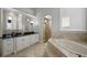 Luxurious bathroom with soaking tub and double vanity at 25602 Grandview Pointe, Sorrento, FL 32776