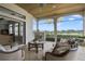 Relaxing screened porch with fireplace and comfortable seating overlooking serene water views at 25602 Grandview Pointe, Sorrento, FL 32776