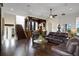 Spacious living area with hardwood floors, leather couches, and a wet bar at 25602 Grandview Pointe, Sorrento, FL 32776