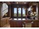Custom wet bar with dark wood cabinets and granite countertop at 25602 Grandview Pointe, Sorrento, FL 32776