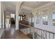 Luxury hallway featuring hardwood floors and an open staircase at 25602 Grandview Pointe, Sorrento, FL 32776