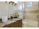 Modern bathroom with granite countertops, a glass-enclosed shower, and a bathtub at 25602 Grandview Pointe, Sorrento, FL 32776