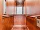 Elegant wooden elevator with wood paneling and brass accents at 25602 Grandview Pointe, Sorrento, FL 32776