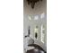 Grand staircase with ornate railing and multiple windows offering scenic views at 25602 Grandview Pointe, Sorrento, FL 32776
