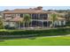 Luxury home with lush landscaping, and palm trees, on a golf course at 25602 Grandview Pointe, Sorrento, FL 32776