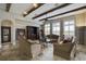 Elegant living room with hardwood floors, large windows, and built-in entertainment center at 25602 Grandview Pointe, Sorrento, FL 32776