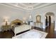 Elegant main bedroom with ornate furniture and a sitting area at 25602 Grandview Pointe, Sorrento, FL 32776