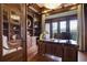 Home office features built-in bookcases, hardwood floors, and a large desk at 25602 Grandview Pointe, Sorrento, FL 32776