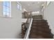 Elegant staircase with wrought iron railing leading to an upper-level sitting area at 25602 Grandview Pointe, Sorrento, FL 32776