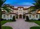 Elegant two-story home with a grand entrance and manicured landscaping at 25602 Grandview Pointe, Sorrento, FL 32776