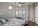 Spacious bedroom with a king-size bed, hardwood floors, and large windows with plantation shutters at 25602 Grandview Pointe, Sorrento, FL 32776