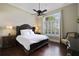 Spacious bedroom with hardwood floors, large window, and a king-size bed at 25602 Grandview Pointe, Sorrento, FL 32776