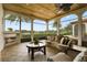 Relaxing screened porch with comfortable seating and a fireplace, overlooking the lake at 25602 Grandview Pointe, Sorrento, FL 32776