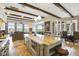 Large kitchen island, stainless steel appliances, and breakfast bar overlooking Gathering room at 25602 Grandview Pointe, Sorrento, FL 32776