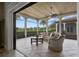 Cozy screened-in porch with seating area, fireplace, and scenic views at 25602 Grandview Pointe, Sorrento, FL 32776