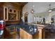 Elegant wet bar with granite countertop, wine rack, and built-in microwave at 25602 Grandview Pointe, Sorrento, FL 32776
