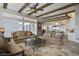 Spacious living room with hardwood floors, large windows and comfortable seating at 25602 Grandview Pointe, Sorrento, FL 32776