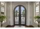 Ornate double entry doors with arched top and wrought iron details at 25602 Grandview Pointe, Sorrento, FL 32776