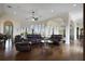 Large living room with hardwood floors, leather furniture, and high ceilings at 25602 Grandview Pointe, Sorrento, FL 32776