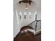 Elegant curved staircase with wrought iron railing and hardwood floors at 25602 Grandview Pointe, Sorrento, FL 32776