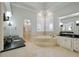 Spa-like bathroom with soaking tub, double vanity, and walk-in shower at 25602 Grandview Pointe, Sorrento, FL 32776