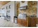 High-end outdoor kitchen with stainless steel appliances and stone countertops at 25602 Grandview Pointe, Sorrento, FL 32776