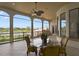 Covered lanai with glass-top table and chairs, overlooking serene landscape at 25602 Grandview Pointe, Sorrento, FL 32776