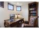 Bright home office with built-in shelving and a comfortable chair at 25602 Grandview Pointe, Sorrento, FL 32776