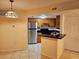 Galley kitchen with stainless steel appliances and wood cabinets at 1916 Lake Atriums Cir # 25, Orlando, FL 32839