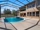 Resort-style pool and spa with covered patio and lush landscaping at 1463 Dunbrooke Loop, Longwood, FL 32779