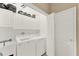 Laundry room with washer, dryer, and overhead storage at 3224 Countryside View Dr, Saint Cloud, FL 34772