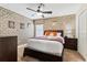 Bedroom with brick accent wall, full bed, and dark wood dresser at 1414 Thunderbird Rd, Davenport, FL 33896