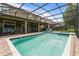 Screened pool and spa with lounge chairs and patio area at 1414 Thunderbird Rd, Davenport, FL 33896