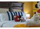 Mickey Mouse themed bedroom with striped pillows and bedding at 1414 Thunderbird Rd, Davenport, FL 33896