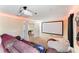 Home theater with large screen, projector, and comfy seating at 1414 Thunderbird Rd, Davenport, FL 33896