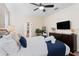 Spacious bedroom with a large bed, dresser, and ensuite bathroom access at 1414 Thunderbird Rd, Davenport, FL 33896
