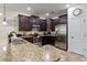 Spacious kitchen featuring dark wood cabinets and granite countertops at 1414 Thunderbird Rd, Davenport, FL 33896