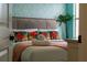 Bedroom with tropical-themed bedding and pillows at 1414 Thunderbird Rd, Davenport, FL 33896