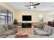 Spacious living room with two sofas, a large TV, and ceiling fan at 1414 Thunderbird Rd, Davenport, FL 33896