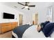 Bright bedroom with a queen-size bed and dresser at 1414 Thunderbird Rd, Davenport, FL 33896