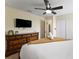 Bedroom with large TV, dresser, and access to hallway at 1414 Thunderbird Rd, Davenport, FL 33896