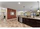 Open kitchen with island, stainless steel appliances, and granite countertops at 1414 Thunderbird Rd, Davenport, FL 33896