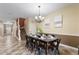 Open concept dining room with a wooden table, six chairs, and views to the entryway and stairs at 1414 Thunderbird Rd, Davenport, FL 33896