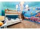 Ocean-themed bedroom with bunk beds and whale mural at 1414 Thunderbird Rd, Davenport, FL 33896