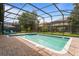 Screened pool and spa with lounge chairs and patio area at 1414 Thunderbird Rd, Davenport, FL 33896