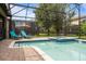 Screened pool and spa with lounge chairs and patio area at 1414 Thunderbird Rd, Davenport, FL 33896