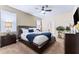 King-size bed, nightstands, and ceiling fan in this bright bedroom at 1414 Thunderbird Rd, Davenport, FL 33896