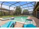 Screened pool and spa with lounge chairs and patio area at 1414 Thunderbird Rd, Davenport, FL 33896